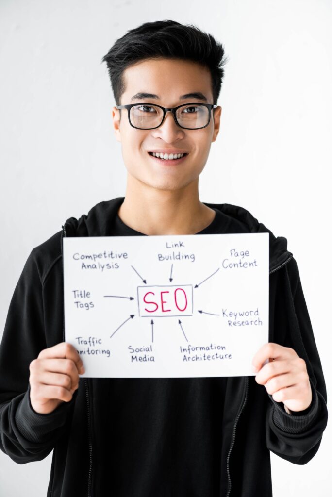 smiling asian seo manager holding paper with concept words of seo